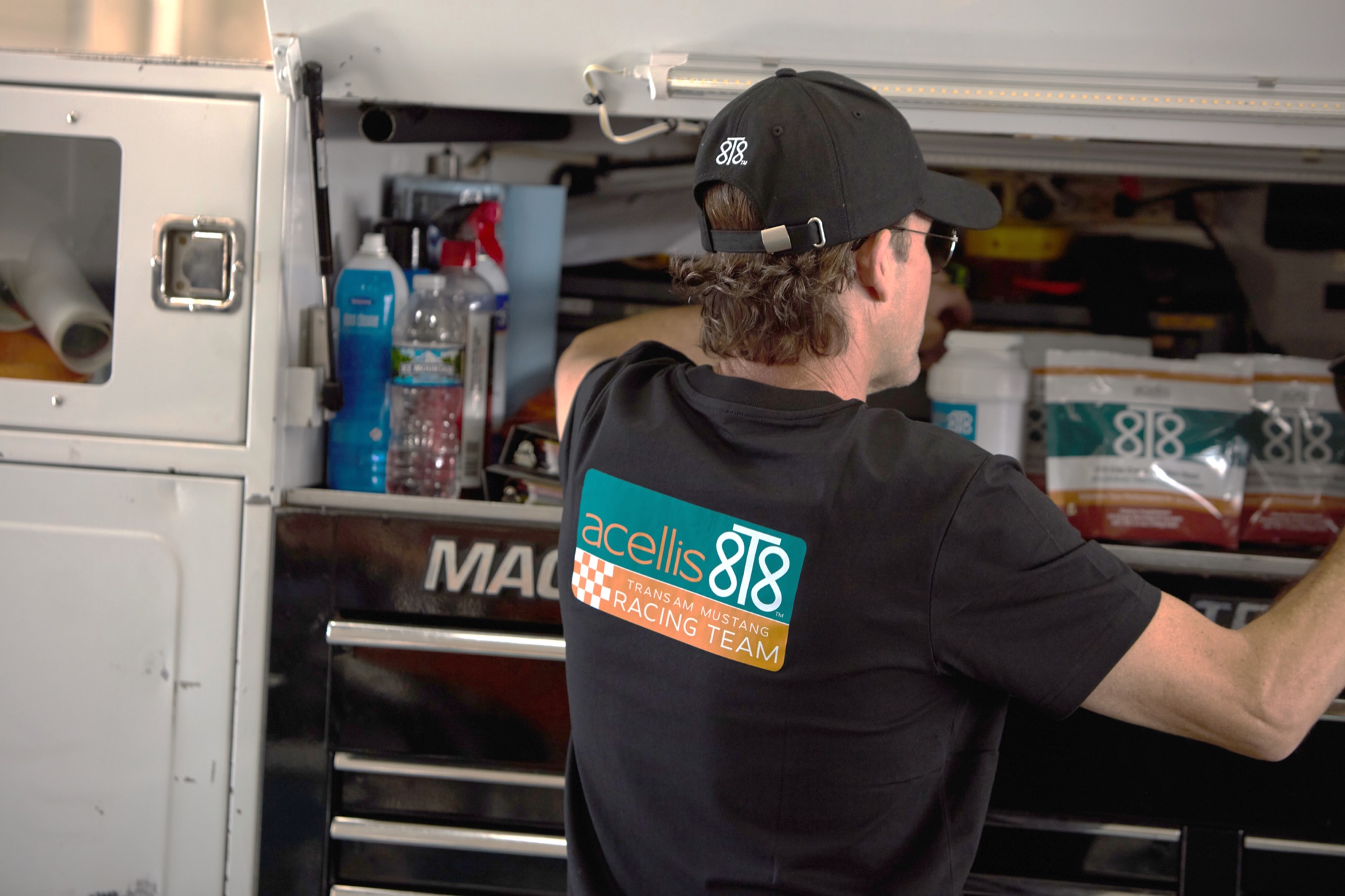 Stanton Barrett working in the team trailer in an Acellis 8T8 shirt