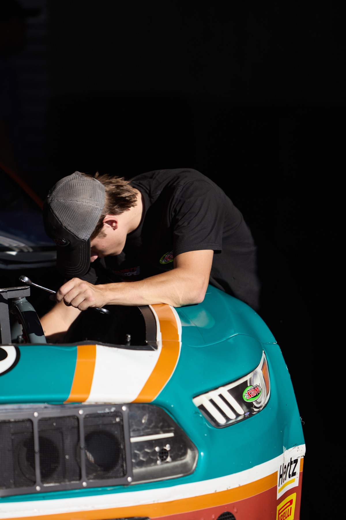 Stanton Barrett working over the hood of the 8T8 car