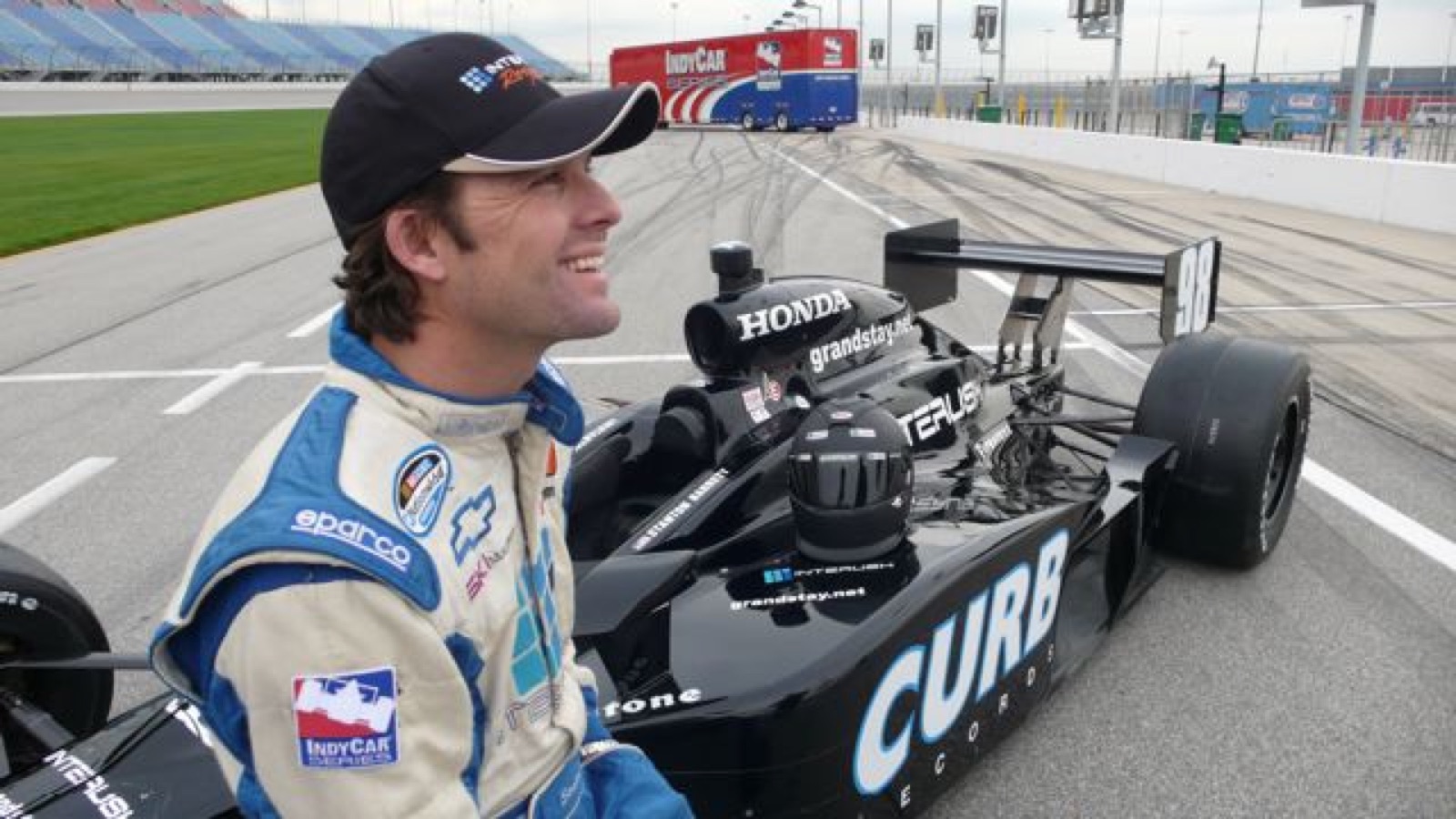 Stanton Barrett beside an IndyCar