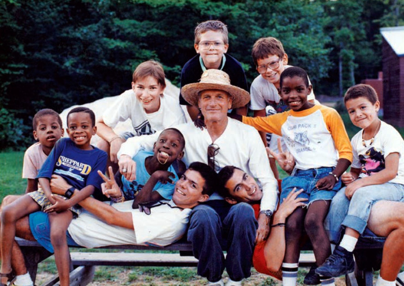 Paul Newman surrounded by children at his camp